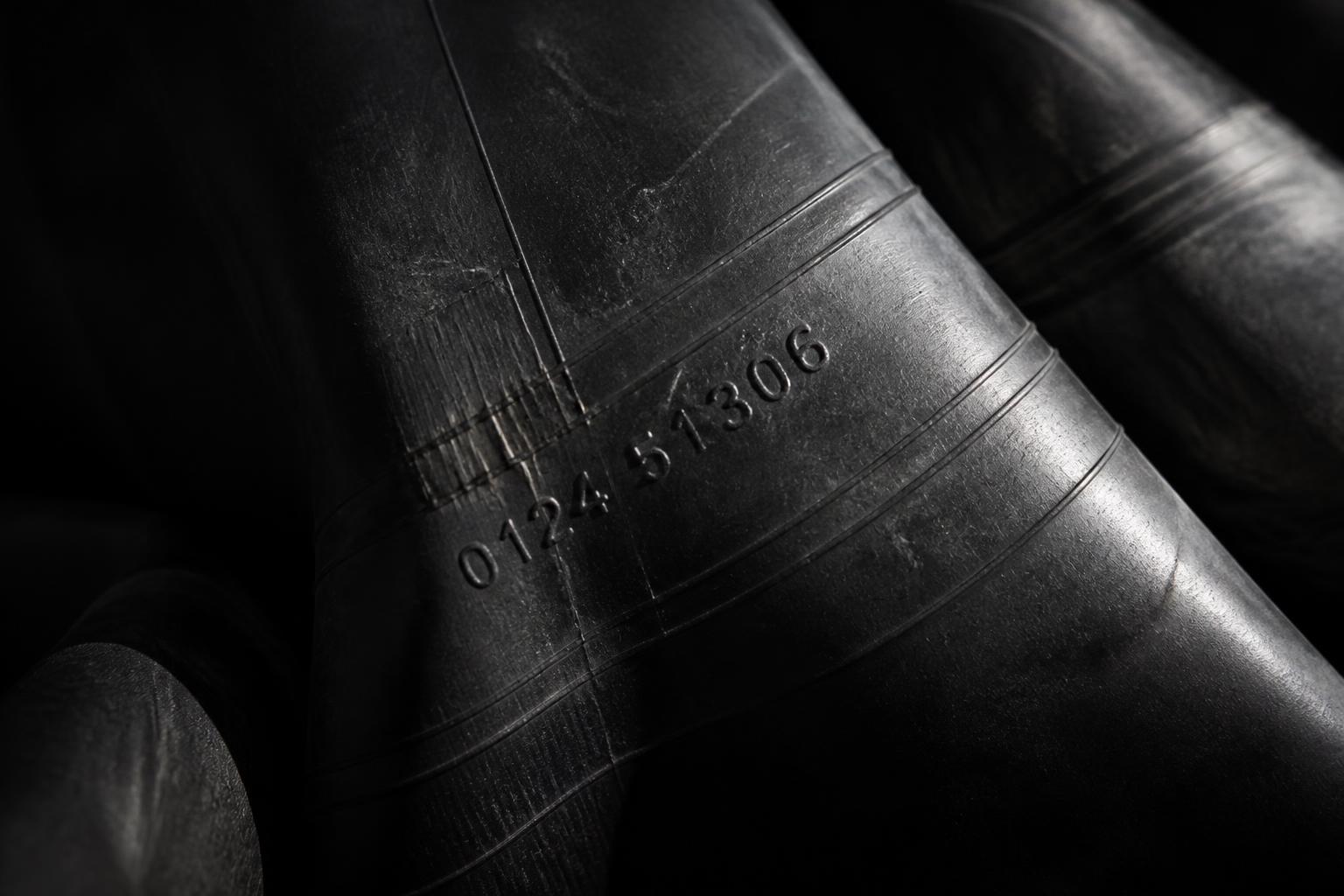 Close-up of reclaimed tyre tube material with embossed markings